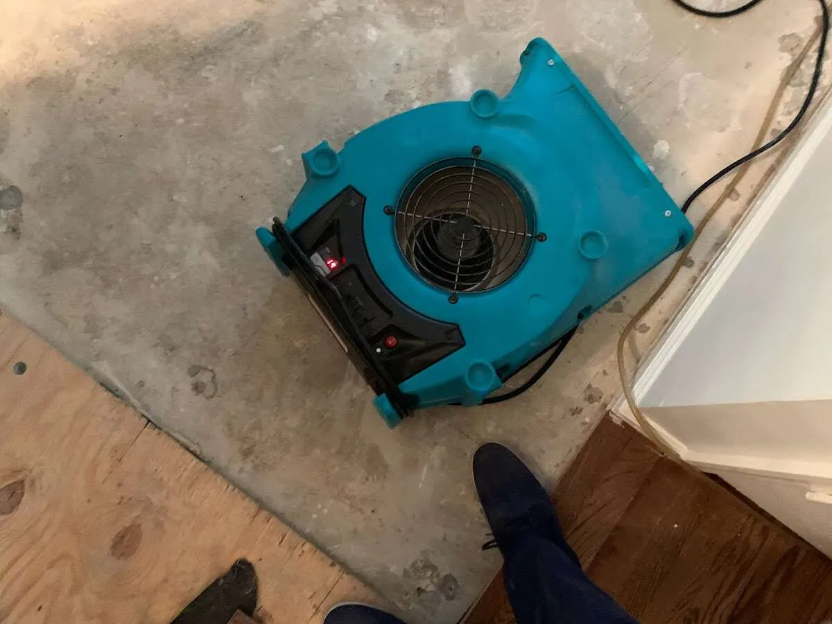 Air mover drying subfloor during Commercial Water Damage Restoration in Burrillville